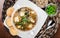 Seafood Soup with salmon, cheese, seaweed, sesame and bread on plate on wooden background. Mediterranean food.