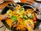 Seafood Spanish Paella with black lips mussels and tiger prawns served in black pan