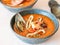 Seafood tomato soup in blue ceramic bowls. Mediterranean cuisine