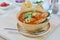 Seafood tomato soup served with garlic bread on cutting board an