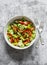 Seafood and vegetables salad. Salad with tomatoes, cucumbers, bell peppers and canned mussels on a grey background, top view