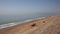 Seaford beach with people in deckchairs, sunbathing and waves East Sussex UK