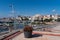 Seafront and harbour with red flowers L`Ampolla, Catalonia, Tarragona Province Spain
