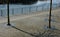 Seafront with plane trees growing out of the lattice in the pavement. a beige concrete staircase serves as a theater bench overloo