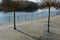 Seafront with plane trees growing out of the lattice in the pavement. a beige concrete staircase serves as a theater bench overloo