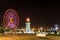 Seafront Promenade In Batumi At Night. Evening Illumination Lights In Ferris Wheel And Old Lighthouse. Seaside Park.