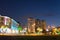 Seafront Promenade In European Nigh Illuminated Resort Town. Evening Illuminations Light In Batumi. Seaside Park With Palm Trees.