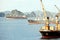 Seagoing vessels, barges, tugboats and small boats at the roadstead of Halong bay under cargo operations and underway. Port of Cam