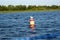 Seagull bird sit on buoy on the lake