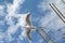 Seagull in flight in front of blue sky past sail masts