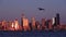 Seagull gliding in front of shiny Seattle skyline