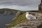Seagull looking out to sea on rugged stone wall along Slea Head Drive in Dingle, Ireland