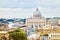 Seagull perched on a pillar overlooking a city on the peters dome, Vatican, Rome, Italy