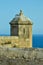A seagull sits on a castle tower of castillo de Santa BÃ¡rbara in Alicante overlooking the Mediterranean Sea