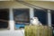 Seagull sits on a post in front of a ship