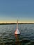 Seagull sitting on a navigation marker buoy in Vistula Lagoon