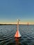 Seagull sitting on a navigation marker buoy in Vistula Lagoon