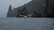 Seagull slow motion flight at backdrop of the rocks and catch pieces of the bread