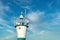A seagull standing on a lighthouse with blue sky background. Navigation, route or direction