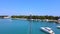 Seagull standing on mast of the motorboat in lagoon bay for docking boats. Aerial view