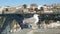 Seagull stands on stone handrail against historical bridge