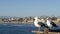 Seagull on wooden pier railings. Bird close up in Oceanside. California. Beachfront houses.