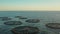 Seagulls circling over a fish farm in the open ocean during sunset