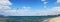 Seagulls hovering in the blue sky with clouds.