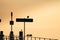 Seagulls Perched on Jetty Sign and Railings with Sun Shining on Lake in the Background