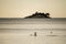 Seagulls resting on the peaceful shore of Rovinj with lonely island visible in the distance during sunset