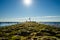 Seagulls sit on sunny on stone pier in the bright sun