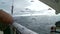 Seagulls soar behind a board of the fishing trawler.