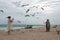 Seagulls Swarm Around Family Taking Photo On Beach