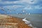 Seagulls taking flight over the pebble beach and english sea in Dungeness Kent