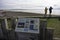 Seal and dolphin sign at Chanonry Point in Scotland with tourist couple