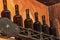 Sealed glass wine bottles are placed on a special decorative shelf in the corner of the room.