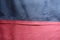 Seam between navy and red artificial suede