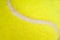 The seam of a yellow tennis ball