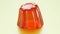 Seamless animation of single orange flavour jelly shaking. Tasty Jello dessert
