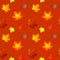 seamless asymmetrical pattern of autumn maple leaves on orange background