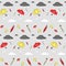 Seamless autumn pattern for fabric for kids with grey and white clouds, red and yellow umbrellas in different positions