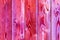 Seamless background of pink stained wooden boards