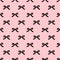 Seamless beauty bow pattern on pink background.