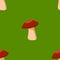 Seamless cartoon colored mushrooms pattern on green background