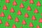 Seamless christmas pattern from sweet tree on green background