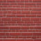 seamless close-up of a red brick wall, rugged and uneven background texture AI-Generated