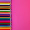 Seamless colored pensils  in a row  on pink  background. Close up. Education, school  concept