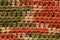 A seamless crocheted texture orange,green and beige