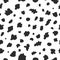 Seamless Dalmatian pattern. Chaotic black spots on white background.