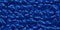 Seamless dark sapphire blue pile of small stone pebbles background texture